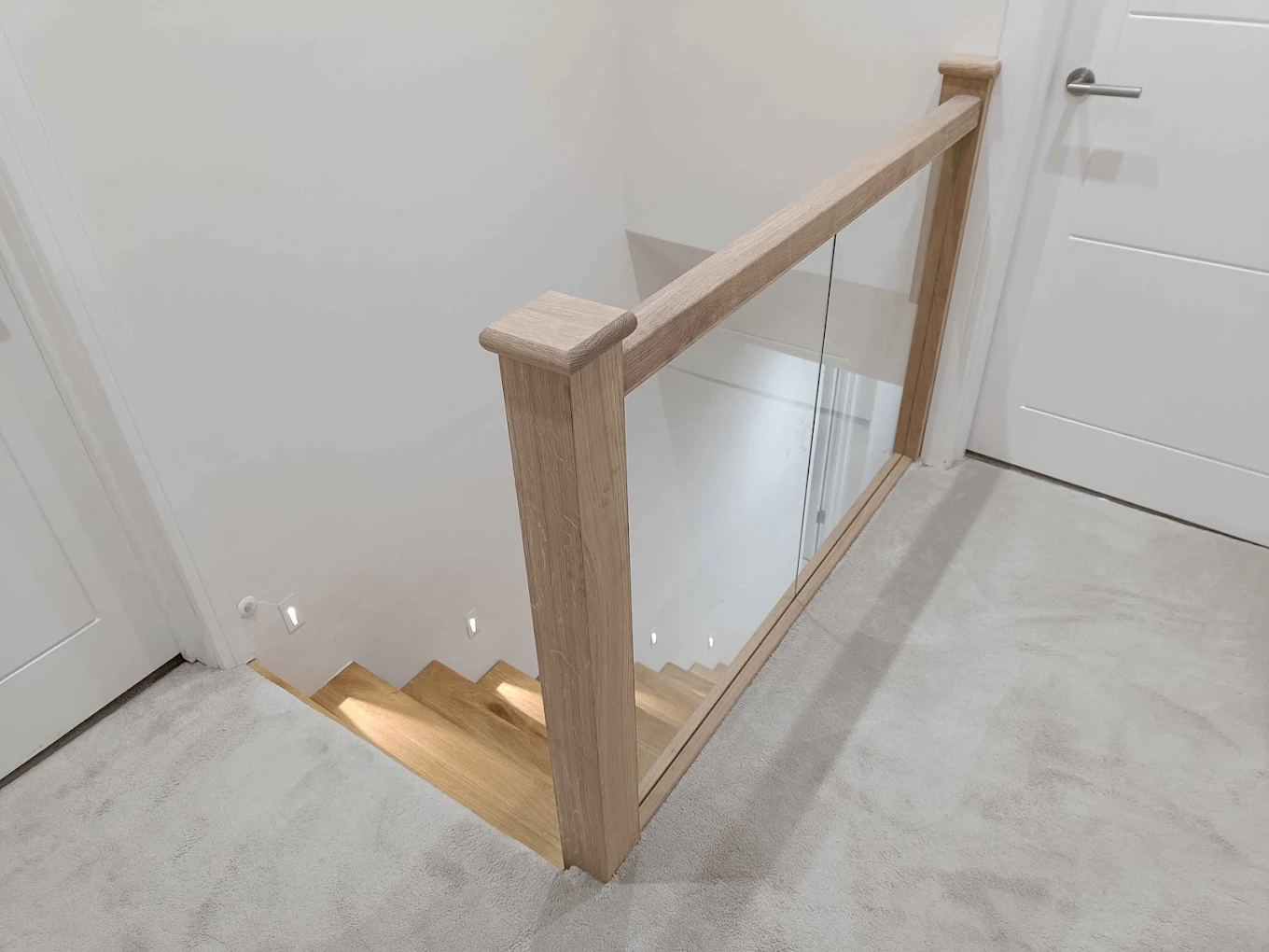 Oak staircase with glass balustrade fitted by Jonner Construction